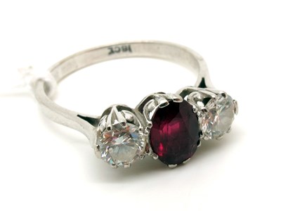 Lot 138 - A Ruby and Diamond Three Stone Ring, claw set...