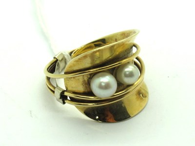 Lot 195 - A Modern Two Pearl Dress Ring, graduated...