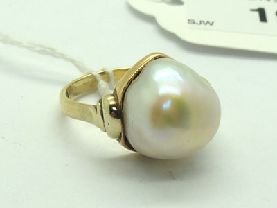 Lot 196 - An Ornate Mabé Pearl Set Dress Ring, between...