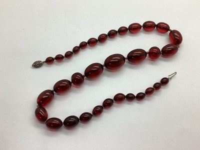 Lot 149 - A Cherry Amber Coloured Bead Necklace, of...