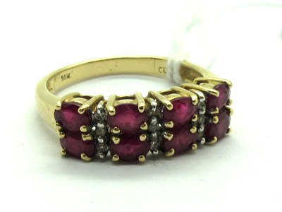 Lot 220 - A Modern Ruby and Diamond Dress Ring, oval...