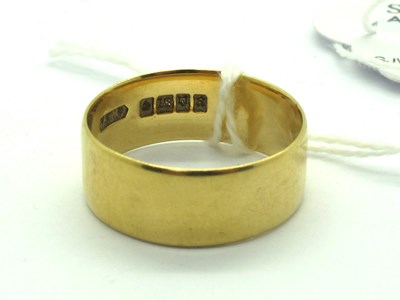 Lot 197 - An 18ct Gold Wide Plain Wedding Band, London...