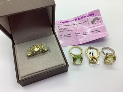 Lot 157 - A Modern Three Stone Lemon Quartz Dress Ring,...