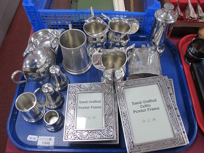 Lot 1348 - Pewter photo frames, a three piece pewter...