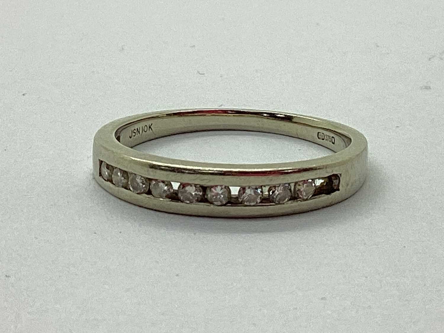 Lot 37 - A Channel Set Diamond Half Eternity Style Ring,...