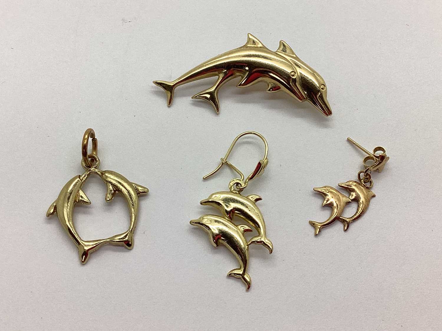 Lot 96 - A Dolphin Design Brooch, featuring two jumping...