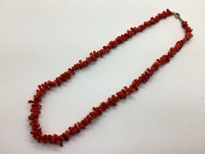 Lot 163 - A Single Strand Coral Coloured Twig Style Bead...