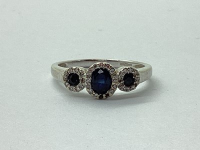 Lot 28 - A 9ct White Gold Sapphire and Diamond Cluster...