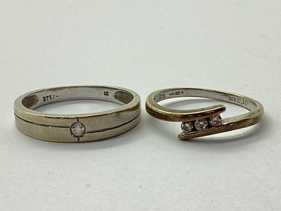 Lot 31 - A 9ct Gold Three Stone Diamond Ring, tension...