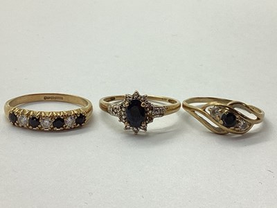 Lot 24 - A 9ct Gold Oval Sapphire and Diamond Cluster...