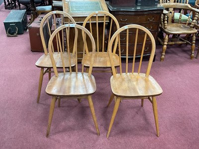 Lot 1640 - Ercol - a set of four blonde hoop and spindle...