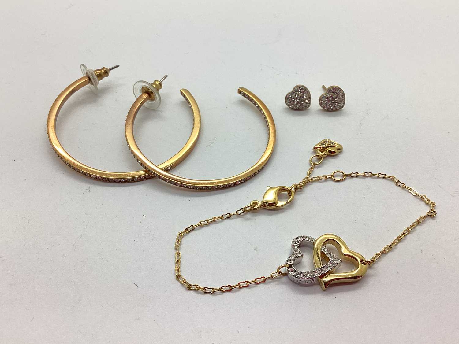 Lot 92 - Swarovski; A Gilt Coloured Interlocking Heart...