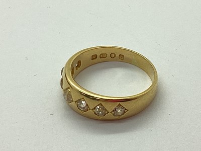 Lot 60 - An 18ct Gold Seven Stone Diamond Band, the old...