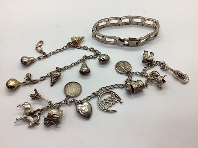 Lot 135 - A Curb Link Charm Bracelet, suspending...