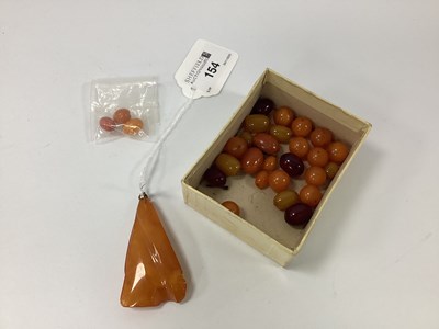 Lot 154 - A Triangular Amber Colour Pendant, (chipped),...