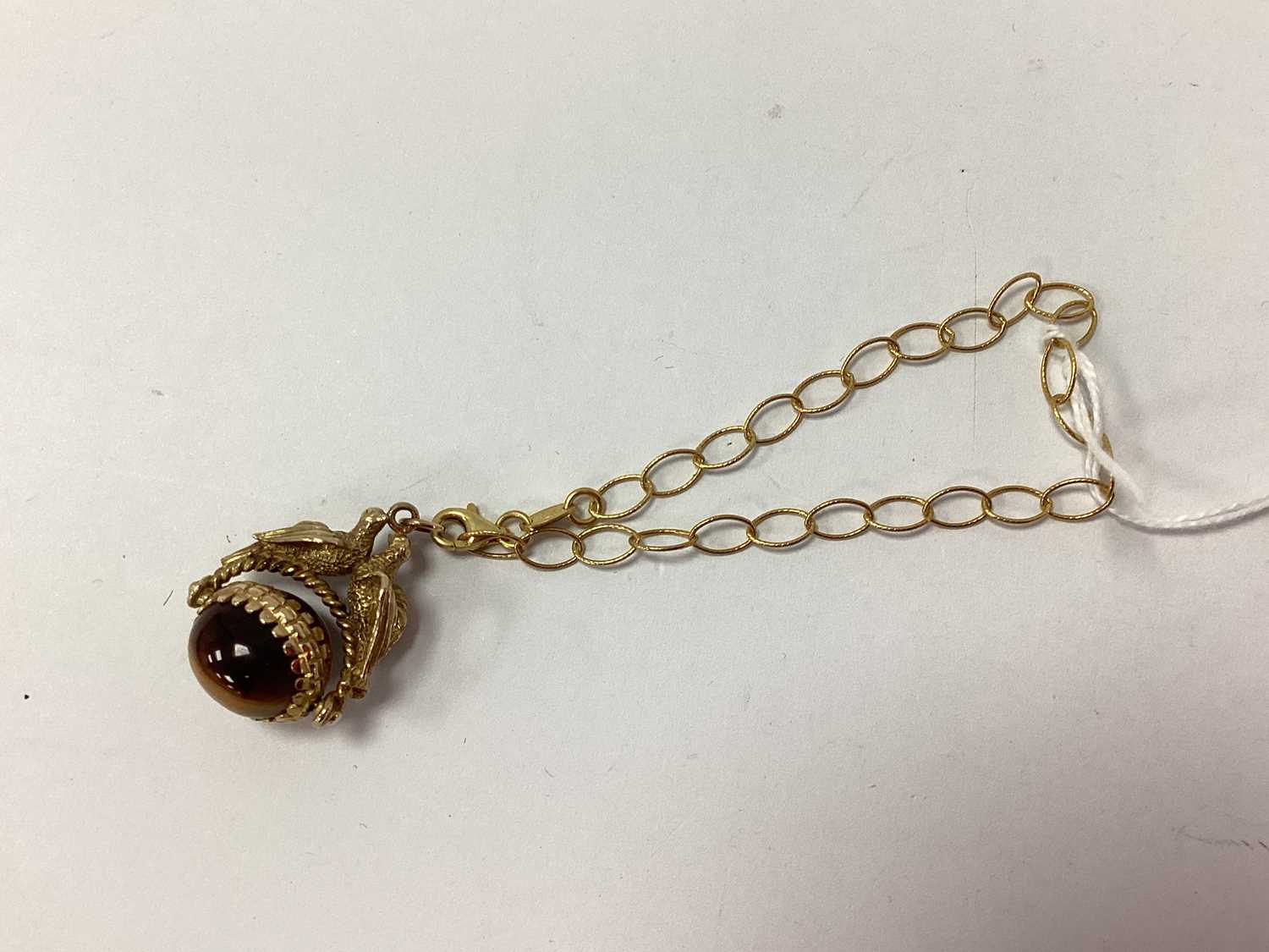 Lot 90 - A 9ct Gold Cabochon Tiger's Eye Inset Swivel...