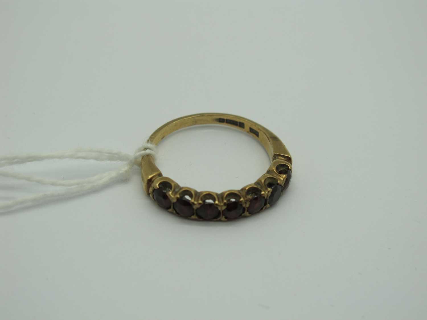 Lot 295 - A 9ct Gold Garnet Half Eternity Style Ring,...