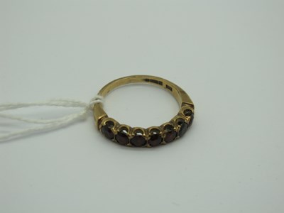 Lot 295 - A 9ct Gold Garnet Half Eternity Style Ring,...