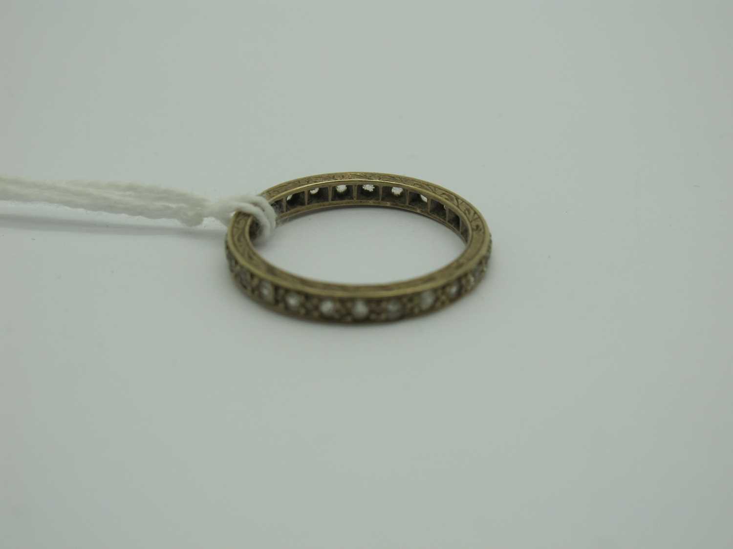 Lot 296 - An Eternity Band, inset throughout, stamped...
