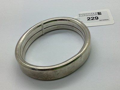 Lot 229 - A Modern Hollow Plain Design Bangle, stamped...