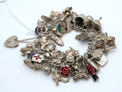 Lot 106 - A Curb Link Charm Bracelet, suspending...