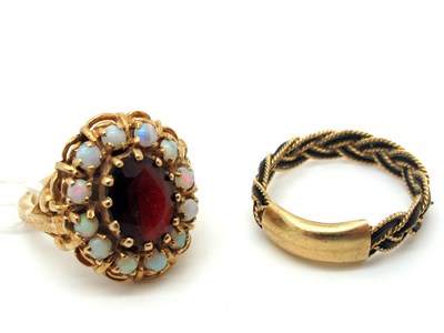 Lot 145 - A 9ct Gold Opal and Garnet Cluster Ring, claw...