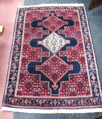 Lot 1385 - A Middle Eastern Rug, the central three...
