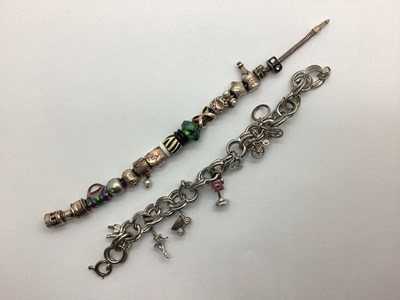 Lot 193 - A Hallmarked Silver Truth Charm Bracelet, with...