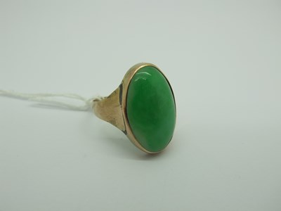 Lot 321 - A Chinese Jade Coloured Ring, oval cabochon...