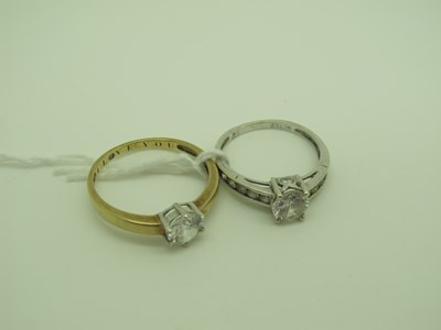 Lot 327 - A Modern Dress Ring, claw set between channel...