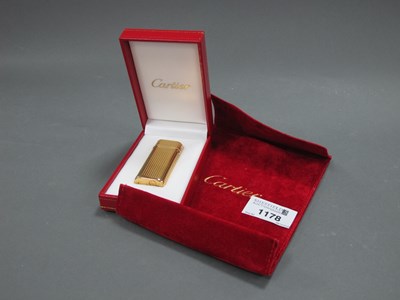 Lot 1178 - A Cartier Lighter, the gold plated case of...