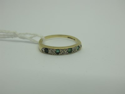 Lot 285 - A 9ct Gold Emerald and Diamond Half Eternity...