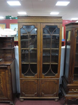 Lot 1507 - A 1920's Oak Bookcase, with glazed doors and...