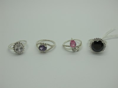 Lot 544 - Four Modern Dress Rings, claw set, stamped...