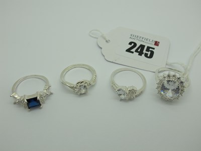 Lot 547 - Four Modern Dress Rings, claw set, stamped...