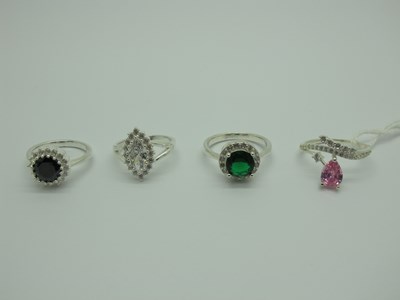 Lot 546 - Four Modern Dress Rings, claw set,...