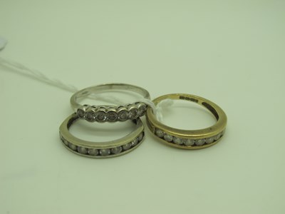 Lot 346 - A CZ Set Half Eternity Ring, stamped "375"...