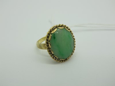 Lot 256 - A Modern Oval Polished Hardstone Ring, within...