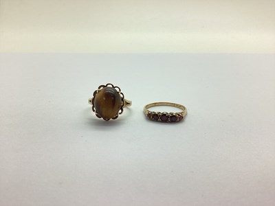 Lot 229 - A Cabochon Claw Set Ring, within an openwork...