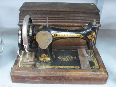 Lot 1434 - Singer sewing machine in an oak case.