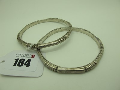 Lot 184 - A Pair of Modern Textured Bangles, stamped "FM"...