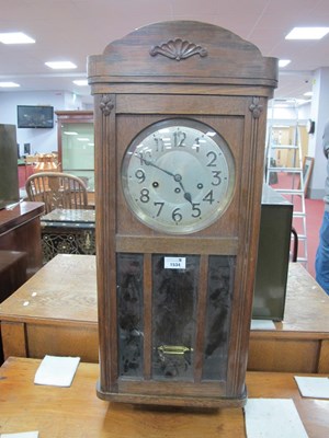 Lot 1534 - A 1940s oak cased wall clock with a silvered...